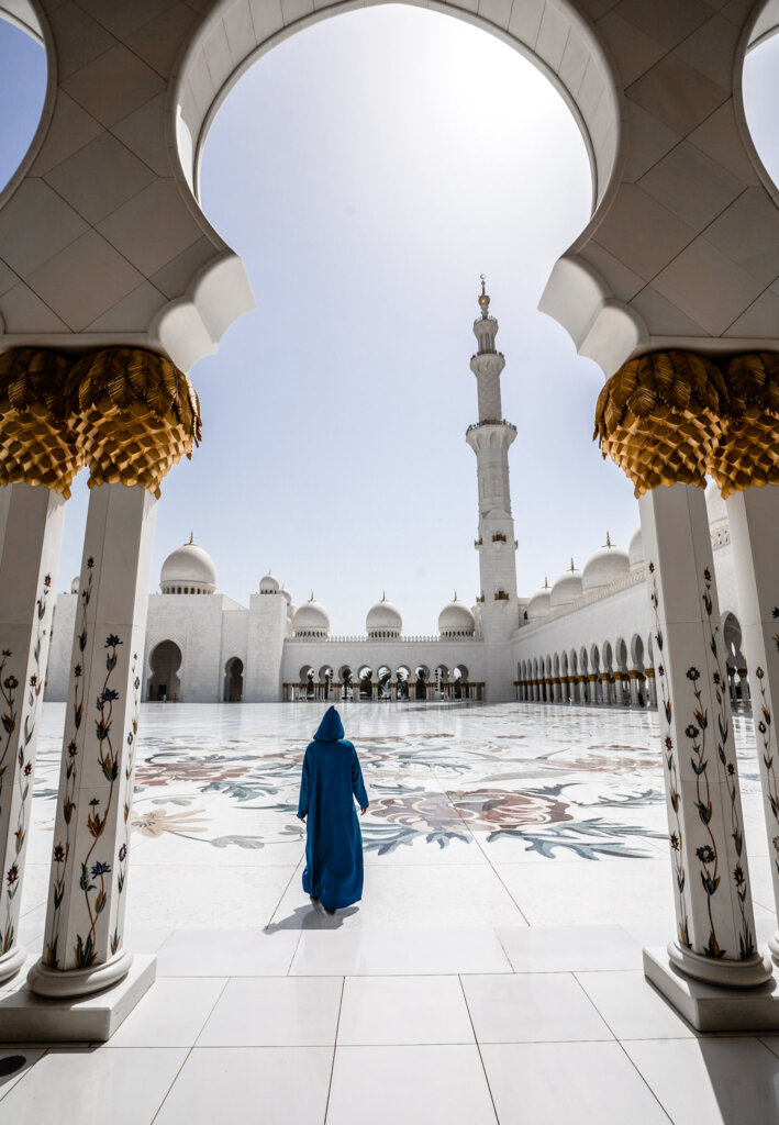 Monica in the glistening white courtyard of the Sheik Zayed Grand Mosque.