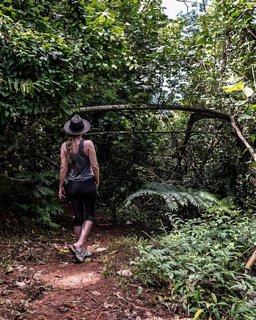Monica hiking on Moorea in the lush jungle.