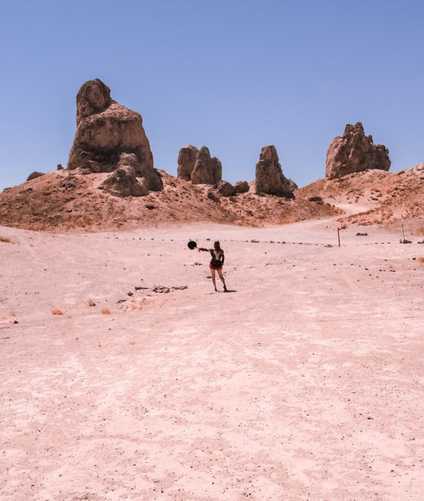 Monica at the Trona Pinnacles with a blue sky behind.
