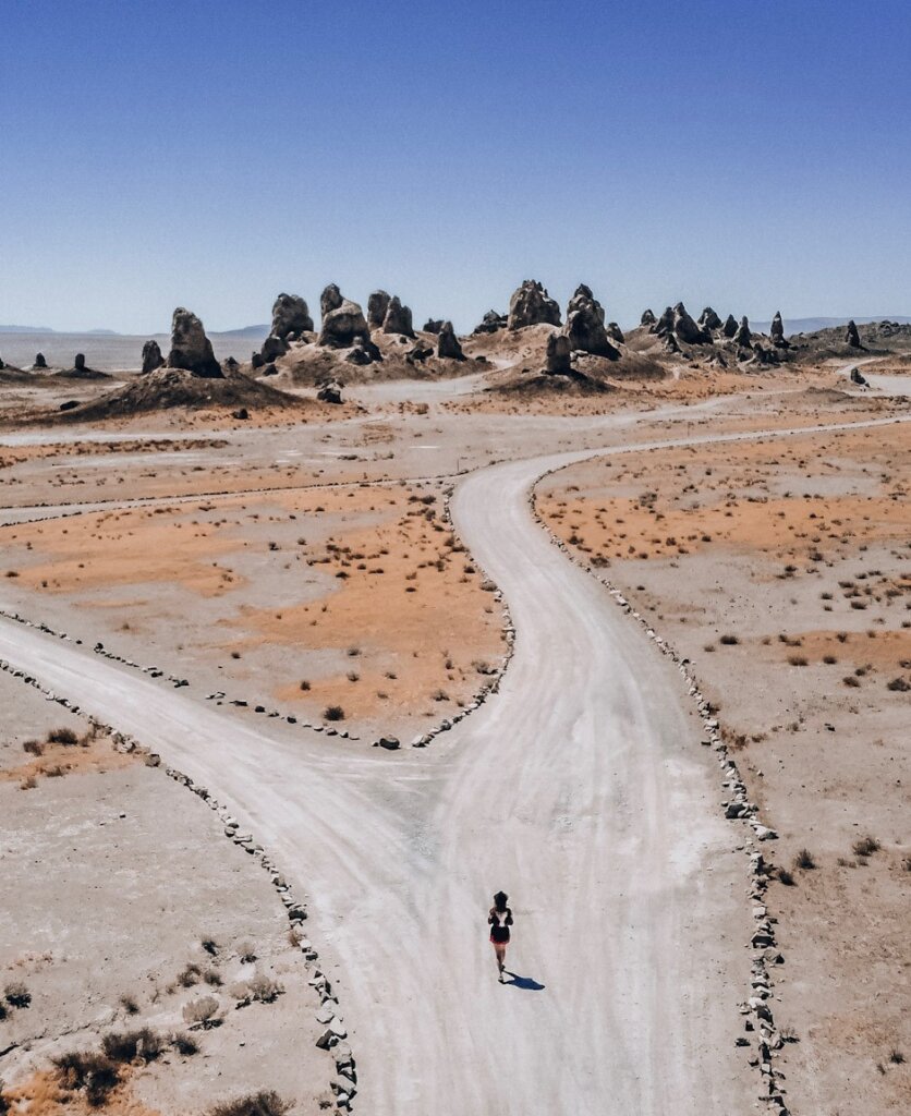 Monica walking toward the Trona Pinnacles on a bright day.