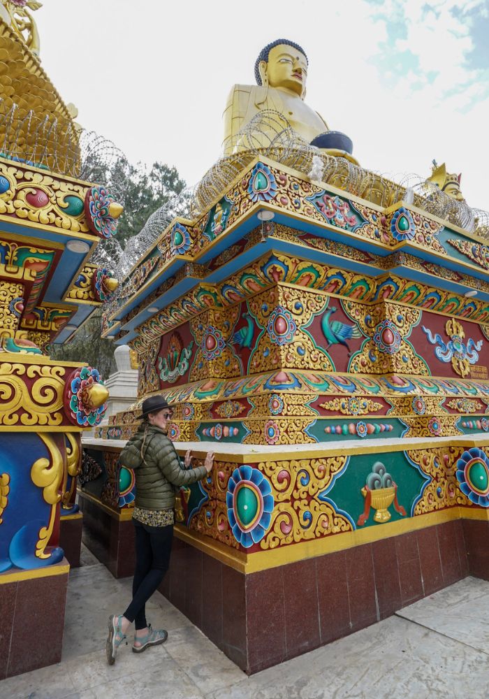 Monica next to the very colorful carvings in Kathmandu - Is Nepal Safe for Solo Female Travel?